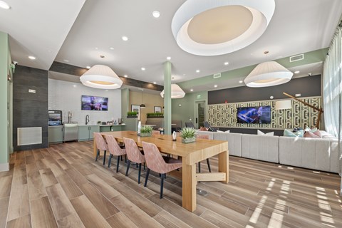A modern dining room with a wooden table and chairs.