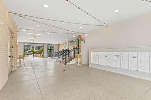 A room with a staircase and a wall of lockers.