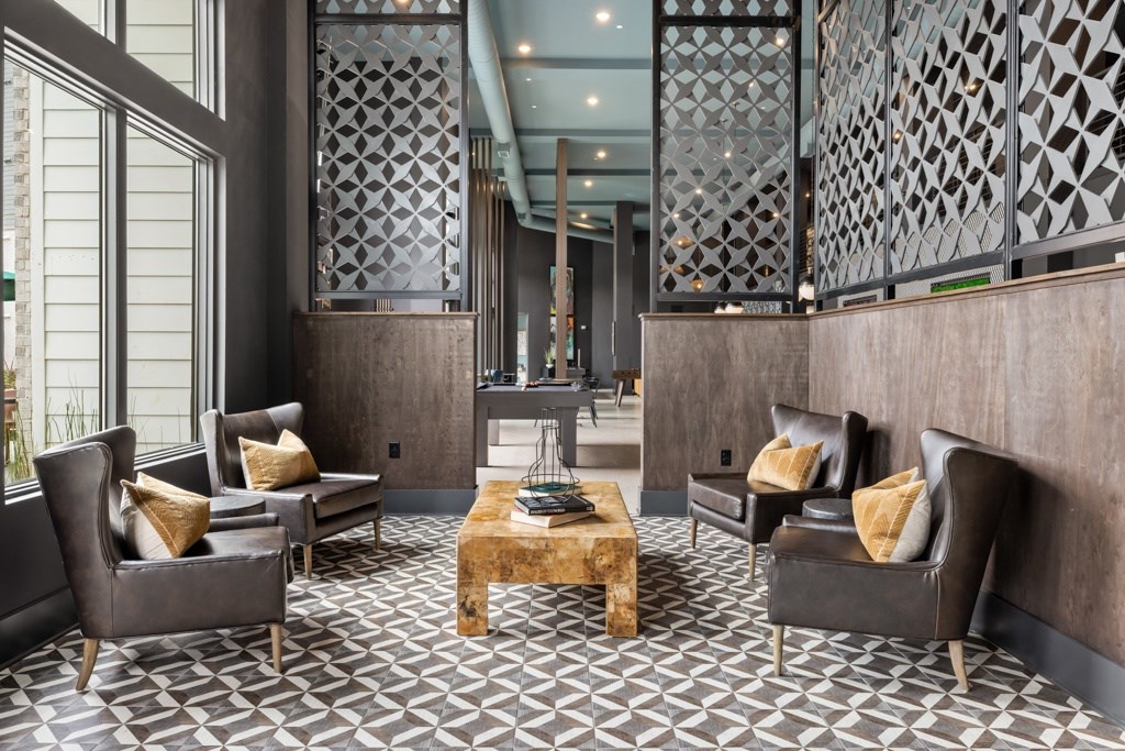 A living room with a patterned floor and dark furniture.