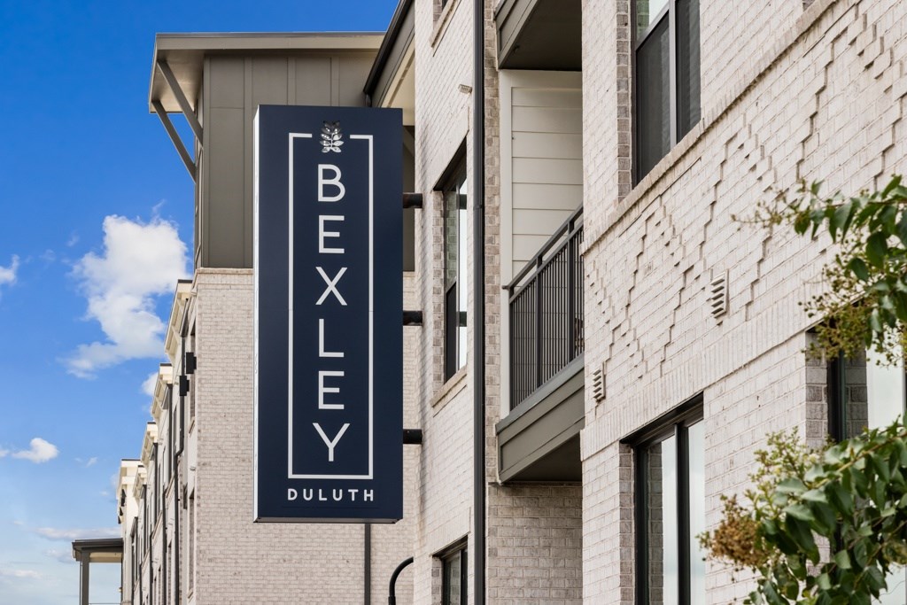 A sign for Bexley Duluth is displayed on a building.
