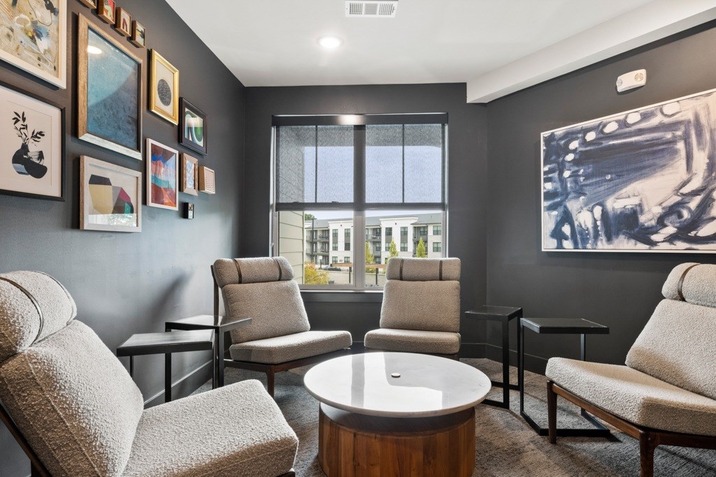 A living room with grey chairs and a coffee table.