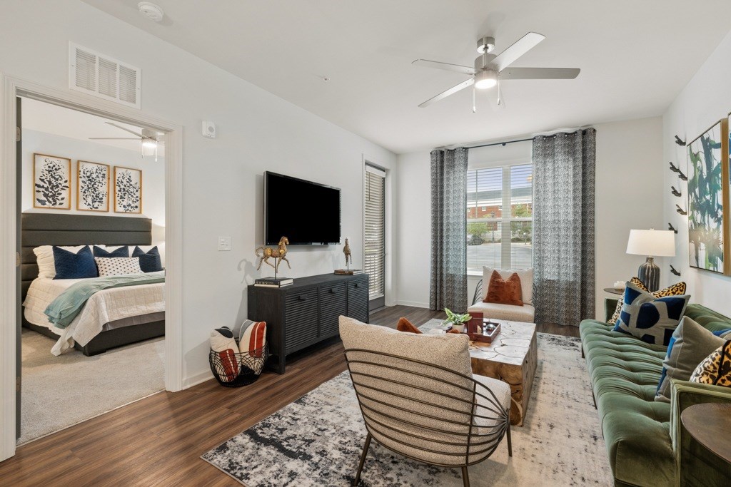 A living room with a green couch and a television.