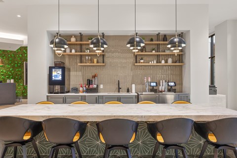 A modern kitchen with a long table and chairs.