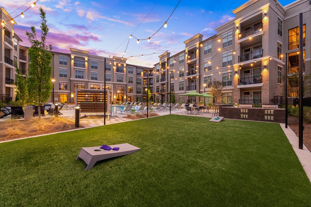 a backyard with a trampoline and a hot tub