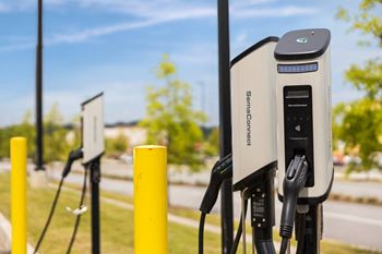 a row of electric car chargers in a park