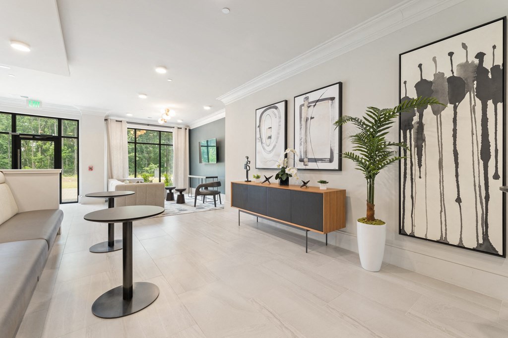 a living room filled with furniture and a large window