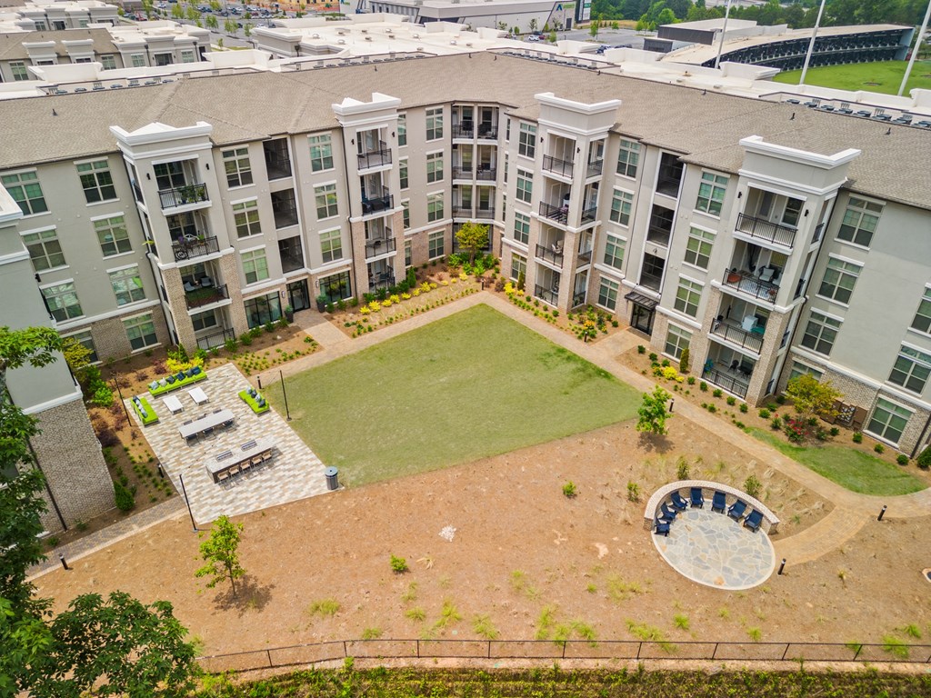 an aerial view of an apartment complex with a large lawn