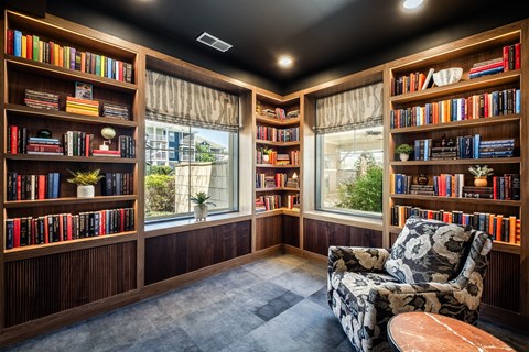 A room with a black ceiling and a chair with a floral pattern on it.
