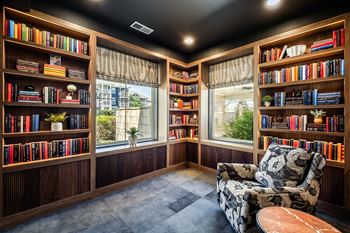 A room with a black ceiling and a chair with a floral pattern on it.