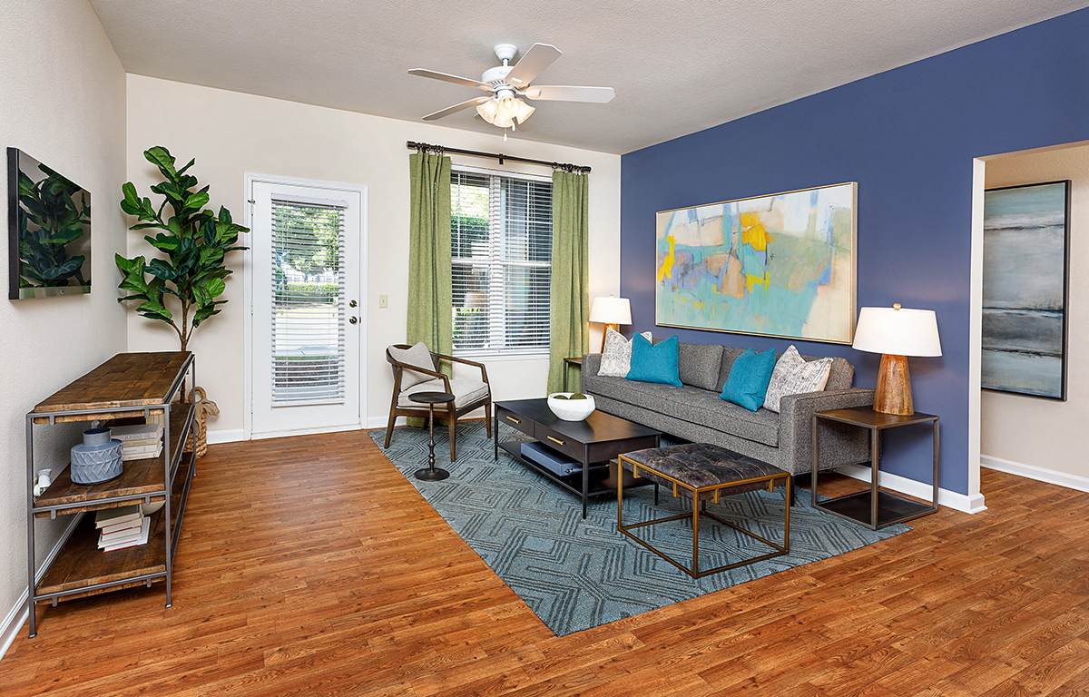 a living room with a couch and a ceiling fan