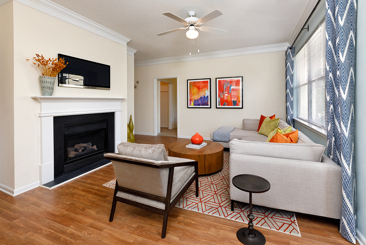 a living room with a couch and a chair and a fireplace