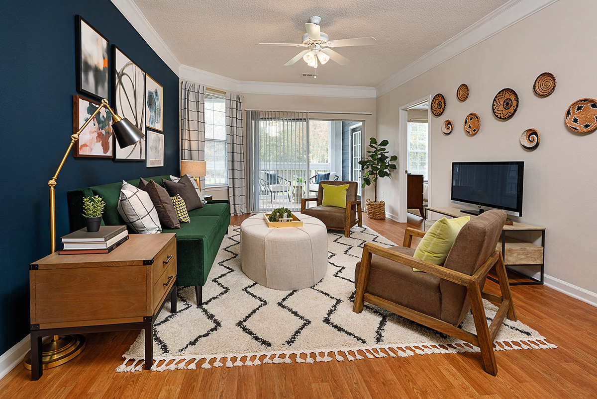 a living room with a green couch and a television