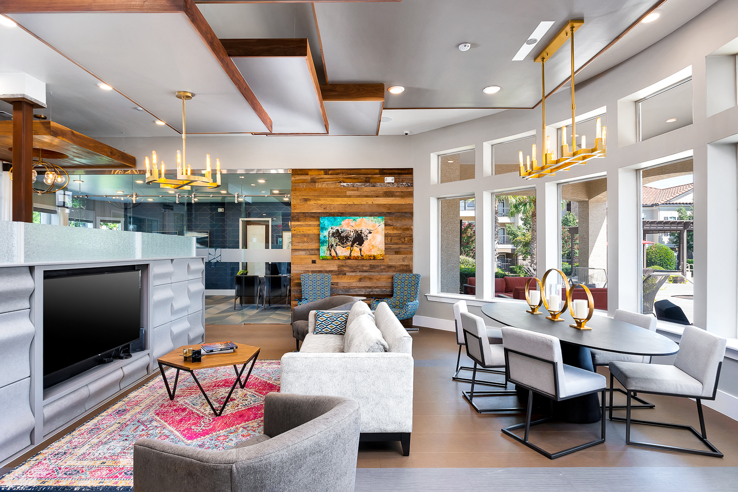 a living room with couches and chairs and a table and a television