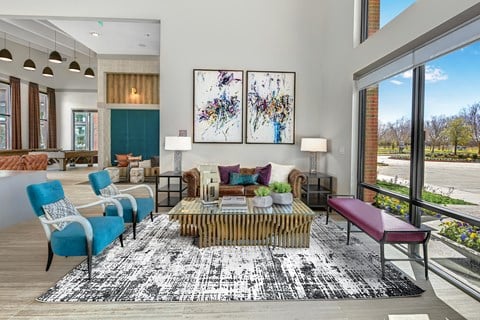 a living room with a large window and a rug