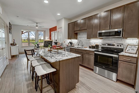 a kitchen with stainless steel appliances and a marble counter top