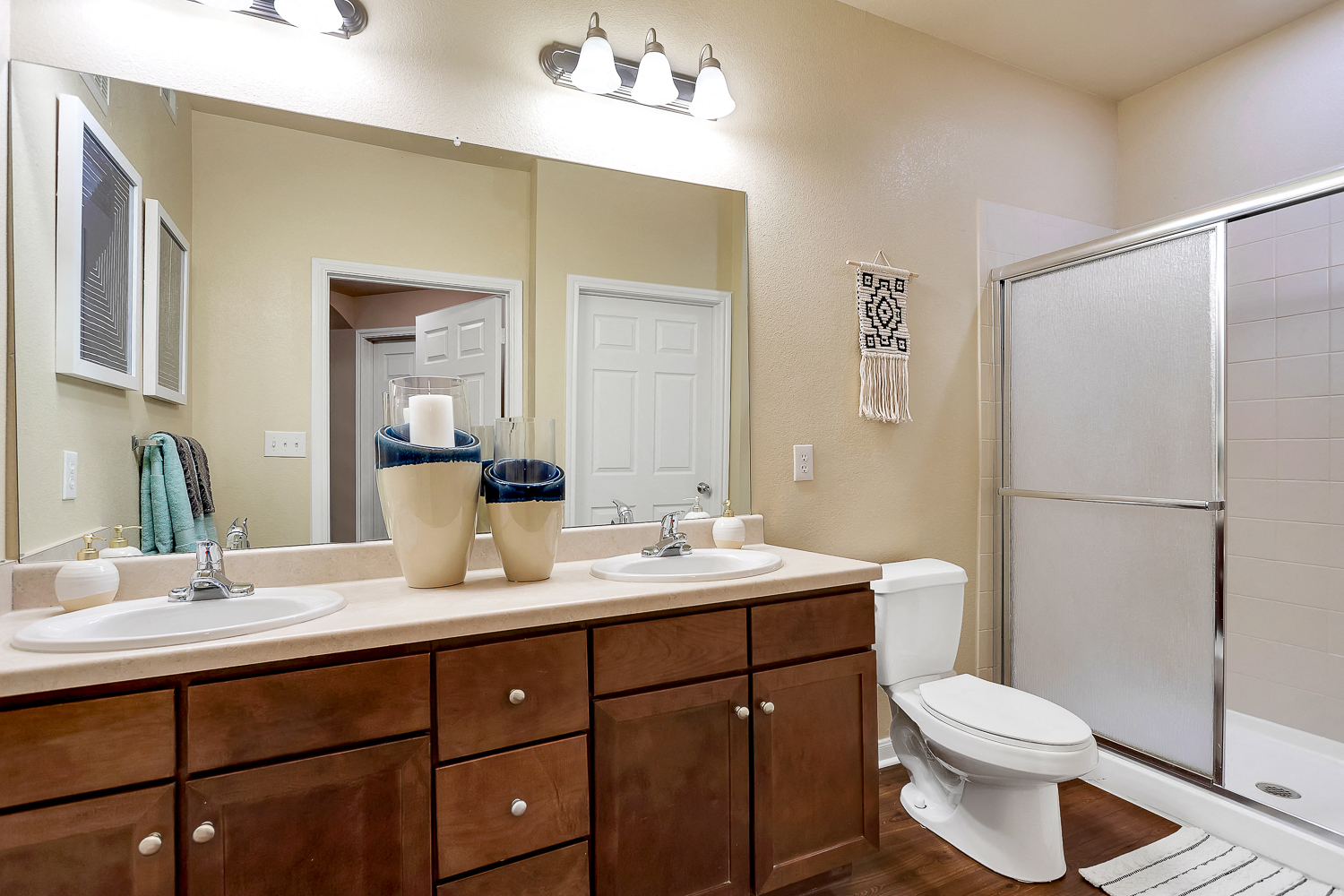 a bathroom with a toilet sink and shower and a mirror