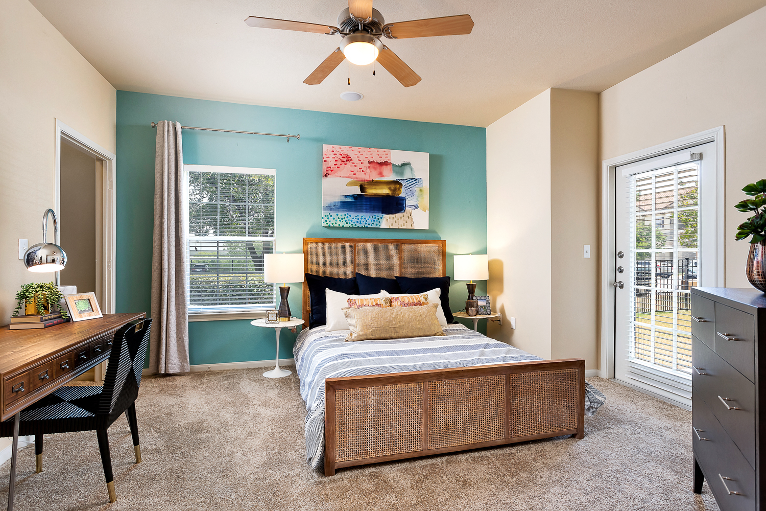 a bedroom with a bed and a ceiling fan