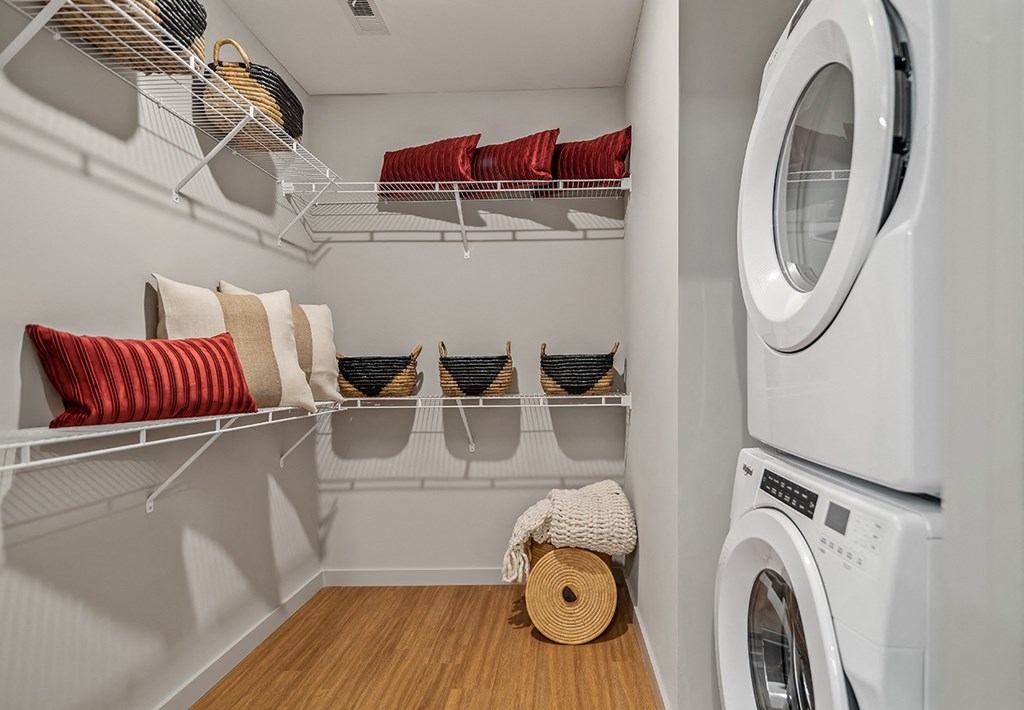 a laundry room with a washing machine and a washer and dryer