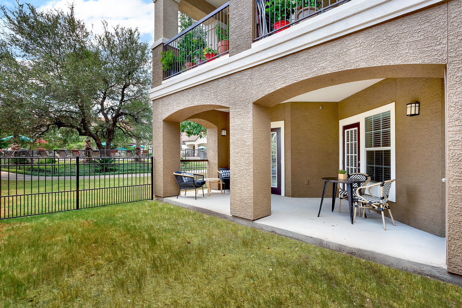a patio with a table and chairs on a balcony