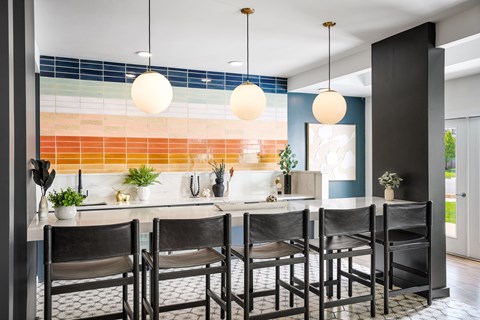 A kitchen with a table and chairs.