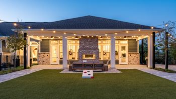 A house with a covered patio and a fireplace.
