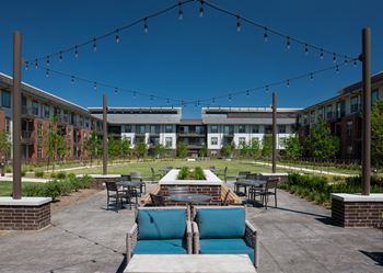 Outdoor Lounge with Covered Grills, Pizza Oven, and Seating Area