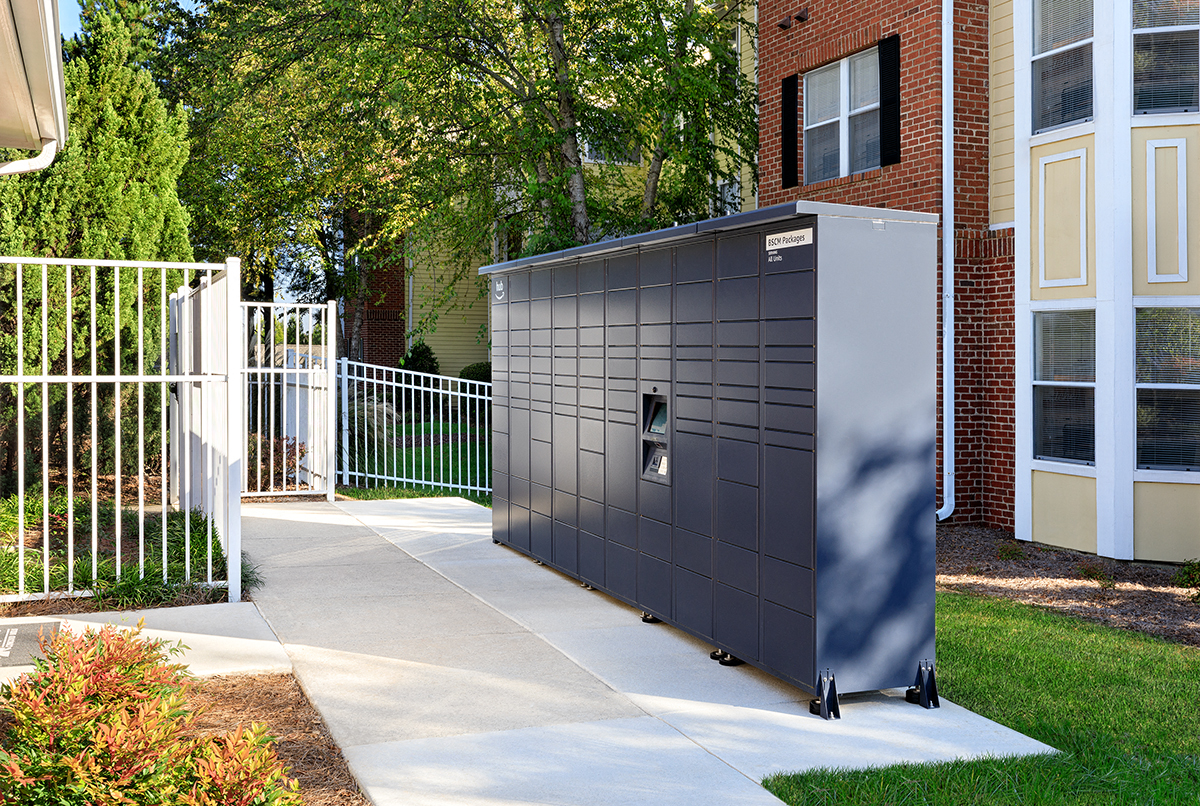 a small storage shed on the side of a sidewalk