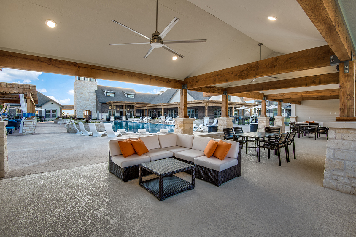 the lobby of a resort with couches and chairs and a pool
