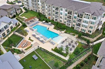 an aerial view of an apartment building with a swimming pool