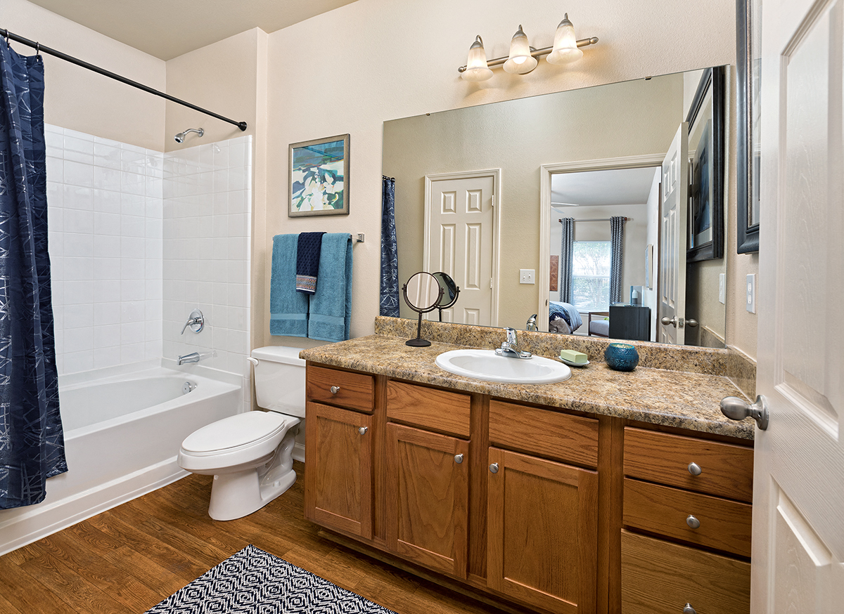 a bathroom with a sink and a toilet and a shower