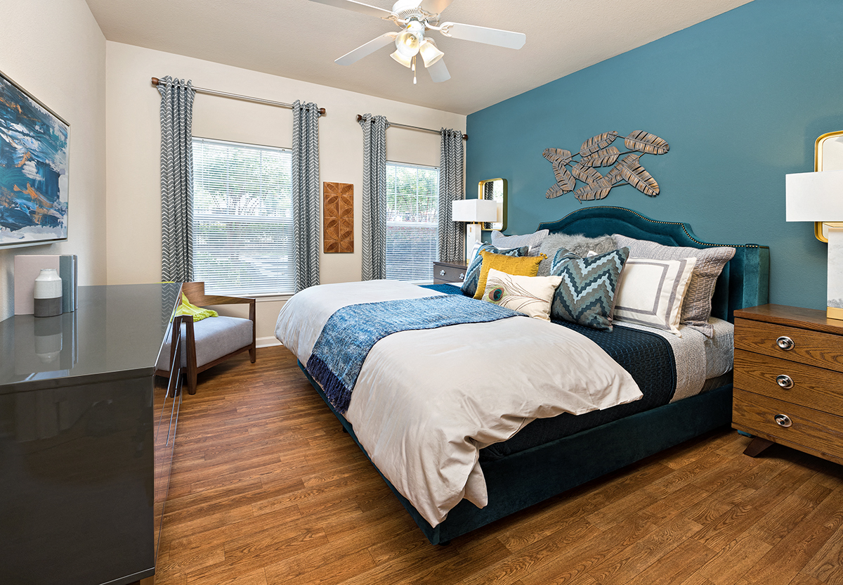 a bedroom with a bed and a ceiling fan