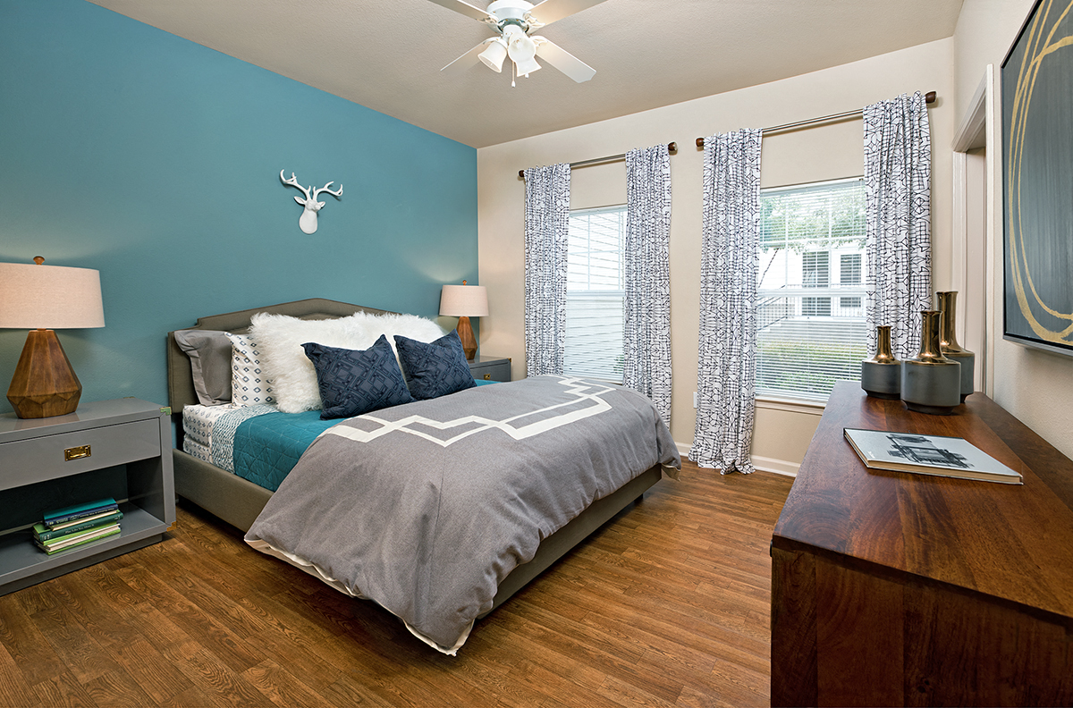 a bedroom with a bed and a ceiling fan