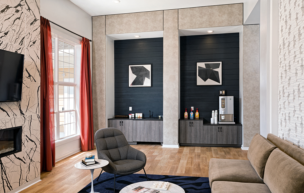 a living room with a couch and a bar in a hotel room