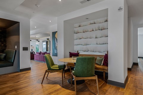 a living room and dining room with a table and chairs