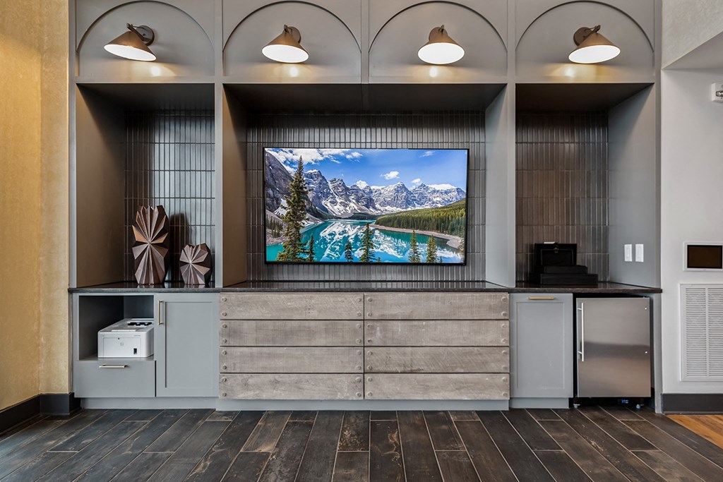 A modern living room with a large screen displaying a mountain landscape.
