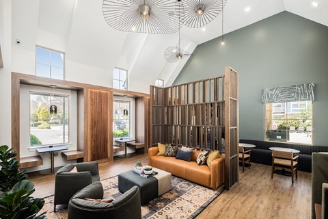 A living room with a large couch and a wooden partition.