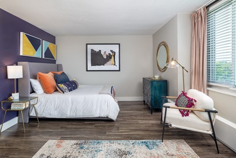 A bedroom with a white bed and a blue cabinet.