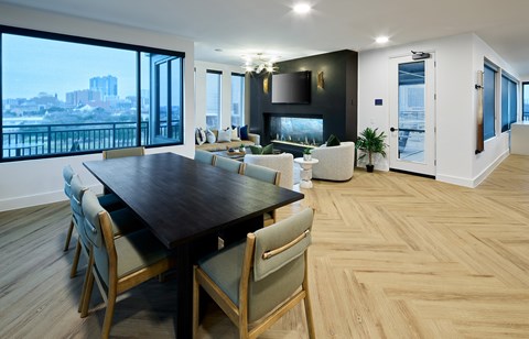 A modern dining room with a large table and chairs.