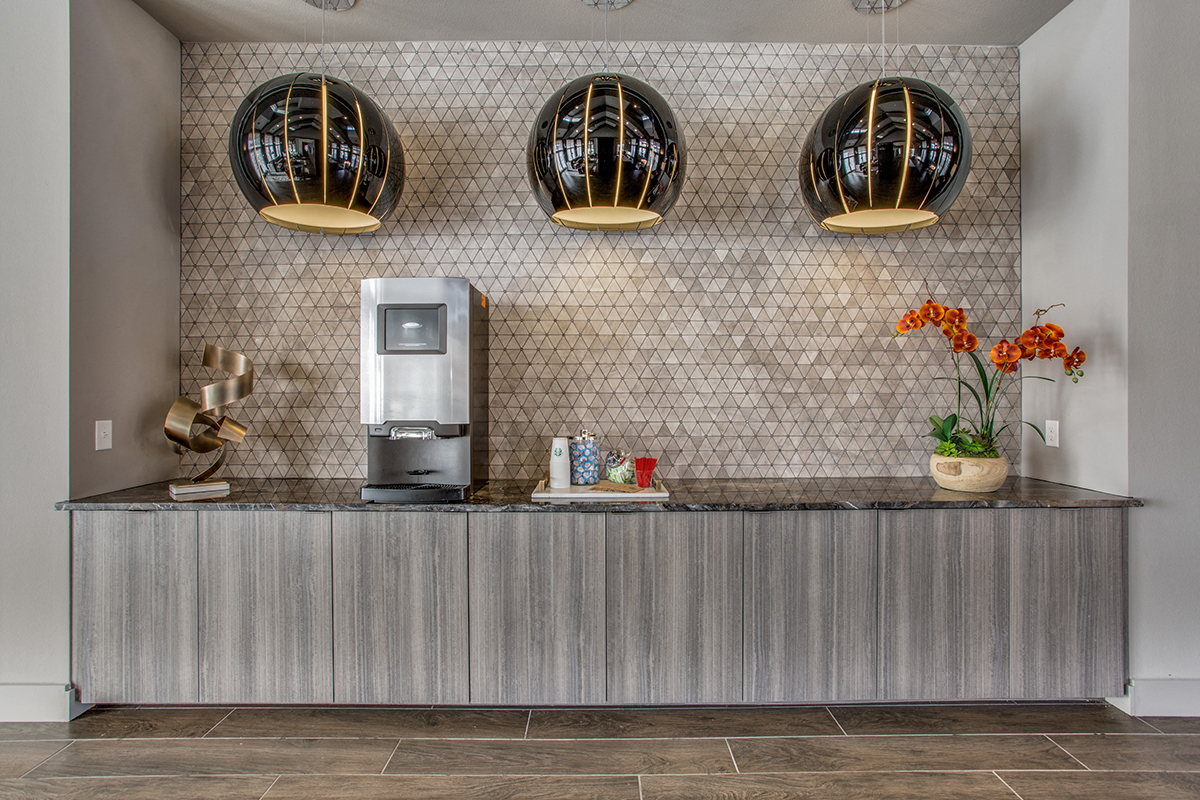 the lobby of a hotel with a coffee machine and a reception desk