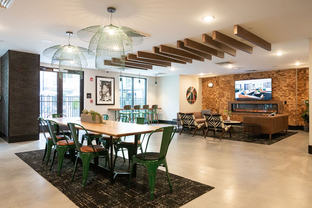 a dining room with a table and chairs and a television