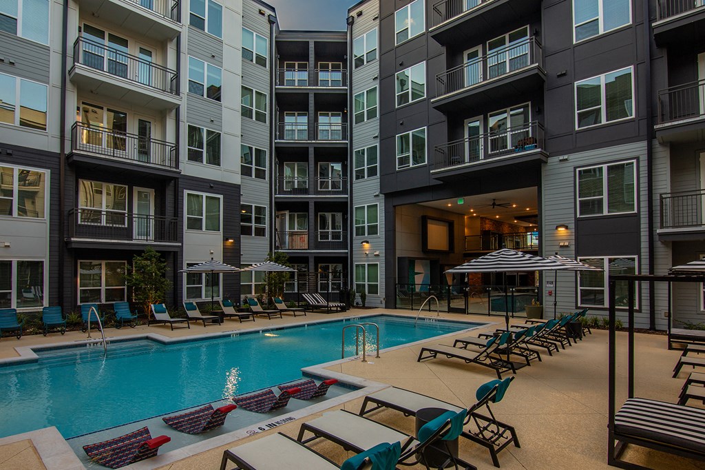 a swimming pool in front of an apartment building