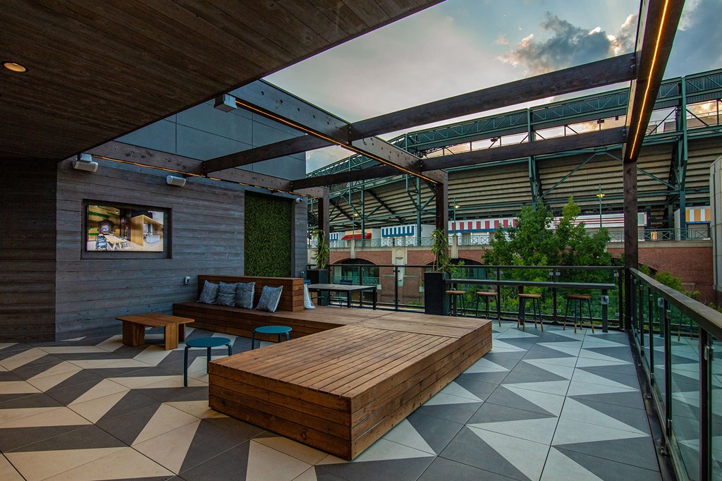a communal area with a wooden bench and a glass roof