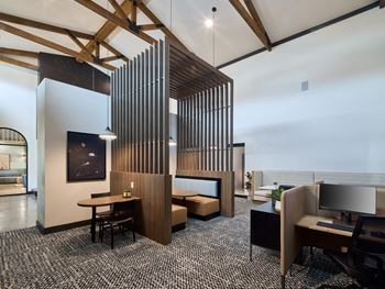 A modern office space with a wooden partition and a black and white checkered floor.