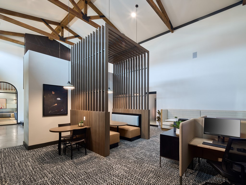 A modern office space with a wooden partition and a black and white checkered floor.