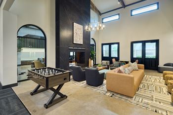 A living room with a pool table and a couch.