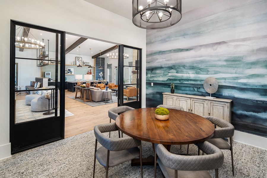 a dining room with a wooden table and chairs