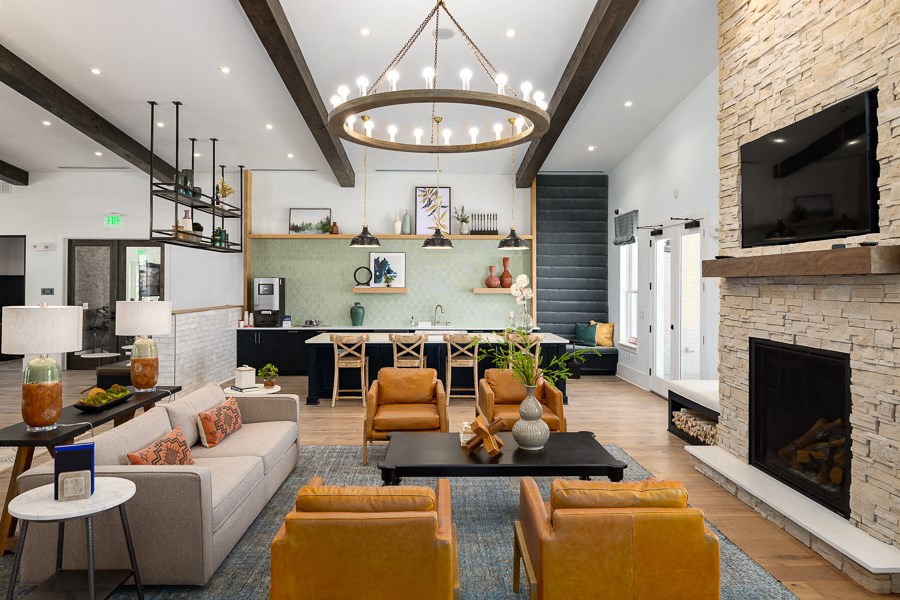 a living room with a fireplace and a dining room