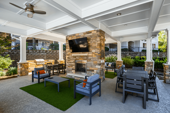 the preserve at ballantyne commons clubhouse patio with fireplace and tables and chairs