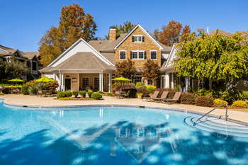 a large swimming pool in front of a house