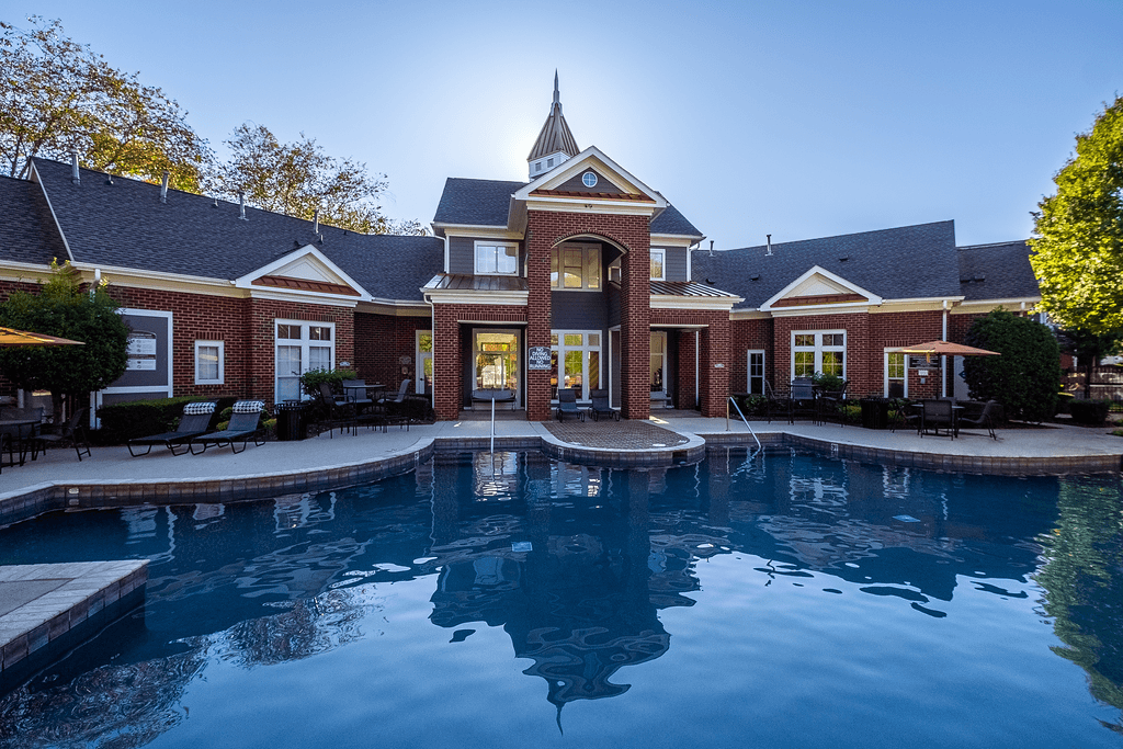 a large swimming pool in front of a house